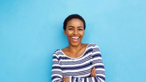 reward smile for positive communication lady with beaming ear to ear smile on blue background